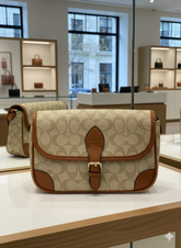 CO ACH SIGNATURE CANVAS BEAT SADDLE BAG WITH LEATHER TRIM LADIES SLING BAG